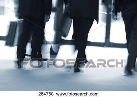 Low section view of businesspeople walking in corridor View Large Photo Image Stock Photo - Low section view of businesspeople walking in corridor . Fotosearch