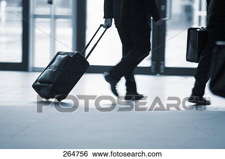 Low section view of businesspeople walking in corridor View Large Photo Image Stock Photograph - Low section view of businesspeople walking in corridor . Fotosearch