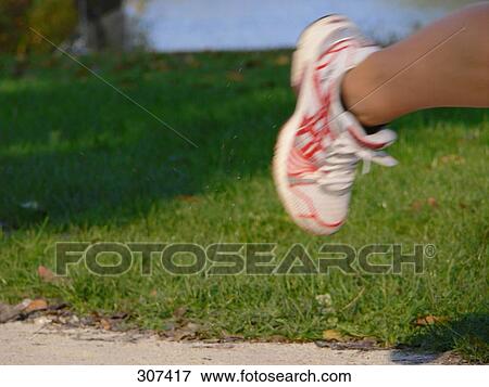 Stock Photo - Low section view of person jogging in park . Fotosearch