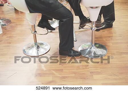Low section view of two businessmen sitting on chairs View Large Photo Image Stock Image - Low section view of two businessmen sitting on chairs . Fotosearch