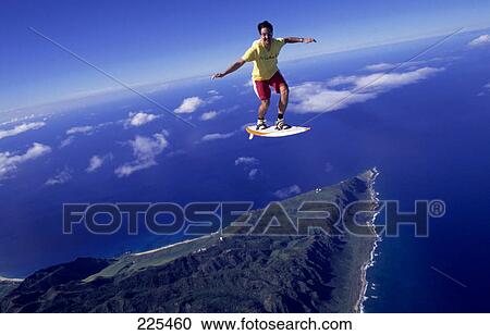 Stock Image - Man flying with surfboard . Fotosearch