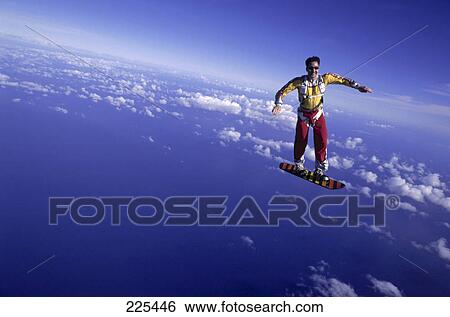 Stock Photograph - Man skydiving on skateboard . Fotosearch