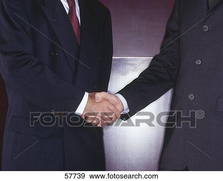 Mid section view of two businessmen shaking hands View Large Photo Image Stock Photo - Mid section view of two businessmen shaking hands . Fotosearch