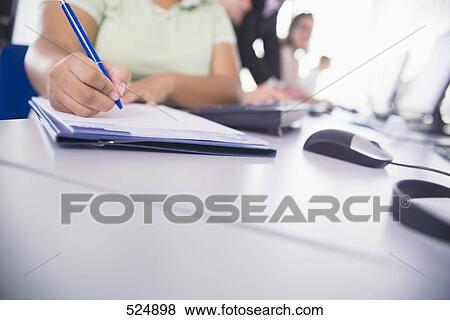 Mid section view of woman writing on notepad View Large Photo Image Stock Photo - Mid section view of woman writing on notepad . Fotosearch