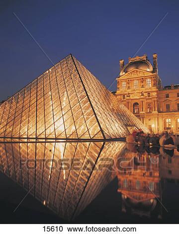 Stock Image - Museum lit up at night, Louvre Pyramid, Musee Du Louvre, Paris, France . Fotosearch
