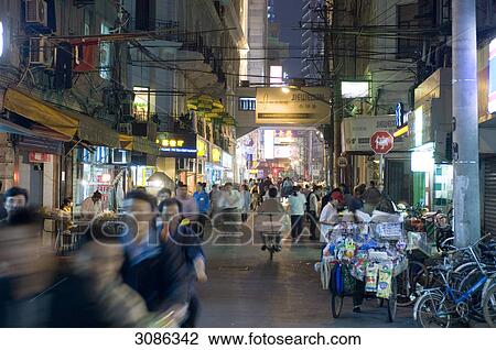 Stock Image - Nanjing Road shopping area at night, Shanghai, China . Fotosearch