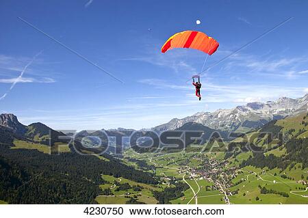 Parachute jumper, Saanen, Canton Bern, Switzerland View Large Photo Image Stock Image - Parachute jumper, Saanen, Canton Bern, Switzerland . Fotosearch