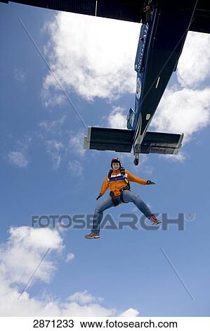 Stock Image - parachute jumper, view from below . Fotosearch