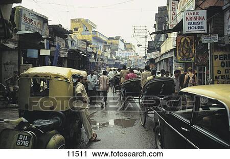 Pedestrians and auto rickshaws on road, New Delhi, India View Large Photo Image Stock Image - Pedestrians and auto rickshaws on road, New Delhi, India . Fotosearch