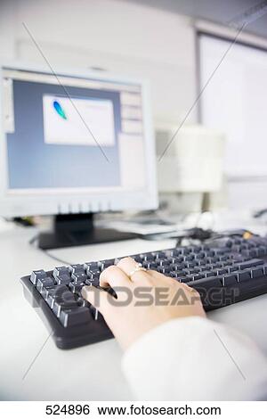 Stock Photograph - Person working on computer . Fotosearch