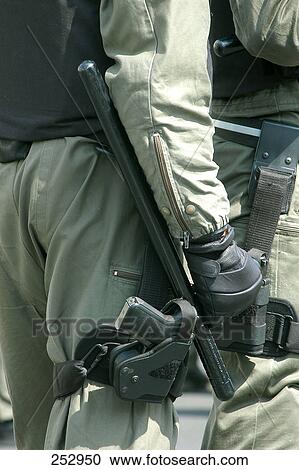 Police officer holding gun View Large Photo Image Stock Image - Police officer holding gun . Fotosearch