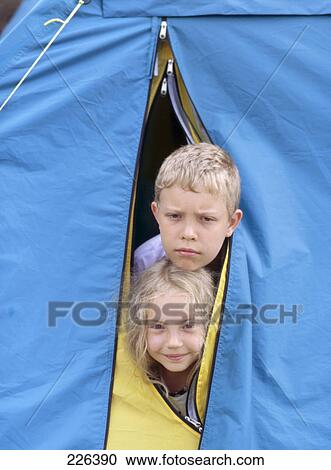 Portrait of boy and girl peeking from camp View Large Photo Image Stock Image - Portrait of boy and girl peeking from camp . Fotosearch