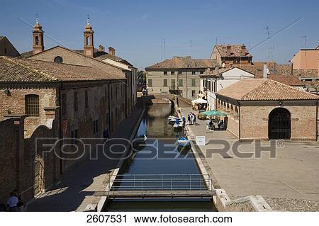 Stock Image - Reflection of buildings in canal, Comacchio, Emilia-Romagna, Italy . Fotosearch