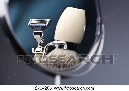 Stock Photography - Reflection of shaving brush and razor in mirror . Fotosearch