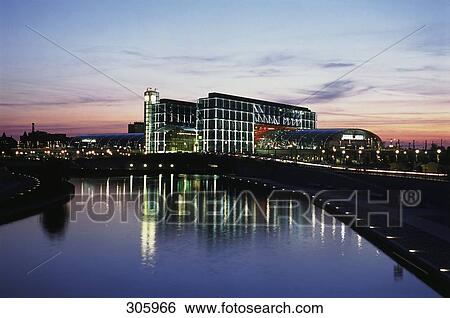 River flowing in front of building at dusk View Large Photo Image Stock Photograph - River flowing in front of building at dusk . Fotosearch