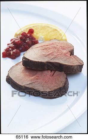 Roast beef, cranberry sauce and slice of orange on plate View Large Photo Image Stock Photograph - Roast beef, cranberry sauce and slice of orange on plate . Fotosearch