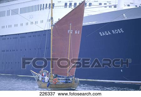 Stock Photo - Sailboat and ship in sea, Rostock, Mecklenburg-Western Pomerania, Germany . Fotosearch