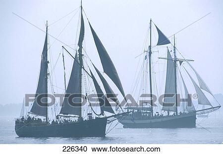 Sailboats sailing in sea View Large Photo Image Stock Image - Sailboats sailing in sea . Fotosearch