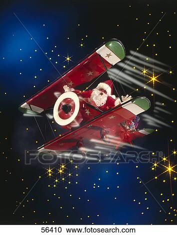 Stock Image - Santa claus on airplane in night sky . Fotosearch