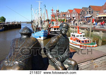 Stock Photo - Sculptures on bridge across river, Neuharlingersiel, Germany . Fotosearch