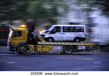 Semi-truck carrying accidental car on road View Large Photo Image Stock Photograph - Semi-truck carrying accidental car on road . Fotosearch