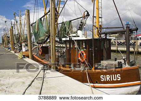 Stock Photo - Shrimp boats in the harbor of Dorum, Germany . Fotosearch