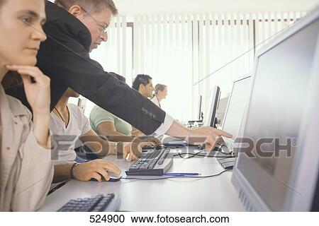 Side profile of businesspeople working on computers View Large Photo Image Stock Image - Side profile of businesspeople working on computers . Fotosearch