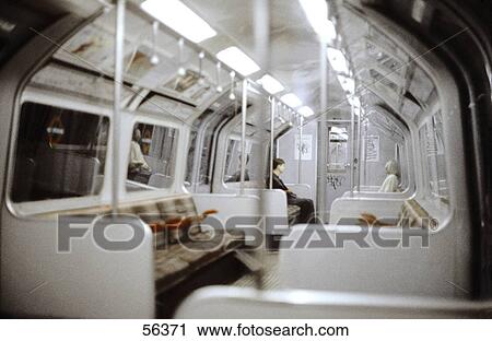 Stock Image - Side profile two people sitting in train . Fotosearch