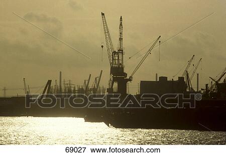Stock Photo - Silhouette of cranes at port, Hamburg, Germany . Fotosearch