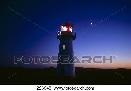 Silhouette of lighthouse at dusk View Large Photo Image Stock Photo - Silhouette of lighthouse at dusk . Fotosearch