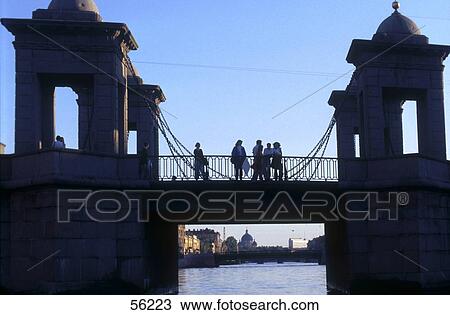 Stock Image - Silhouette of tourists standing on bridge, Saint Petersburg, Russia, Europe . Fotosearch