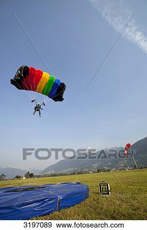 Stock Photo - Skydiver landing, Locarno, Tessin, Switzerland, slanted view . Fotosearch