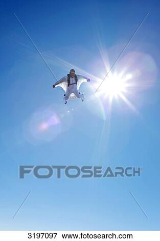 Stock Photo - Skydiver with wingsuit, Reichenbach, Bern, Switzerland . Fotosearch