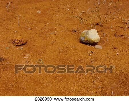 Stock Image - Stones on red sandy landscape, La Gomera, Canary Islands, Spain . Fotosearch