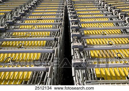 Supermarket shopping trolleys in rows View Large Photo Image Picture - Supermarket shopping trolleys in rows . Fotosearch