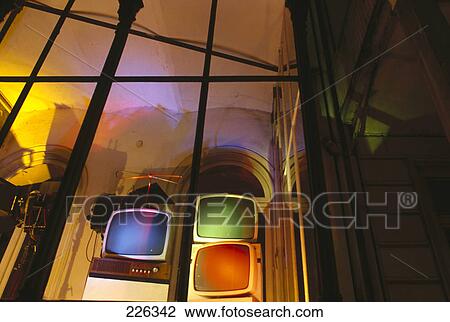 Stock Image - Television sets inside lit up room . Fotosearch