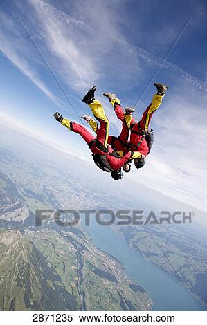 Stock Photography - three parachute jumpers, full shot . Fotosearch