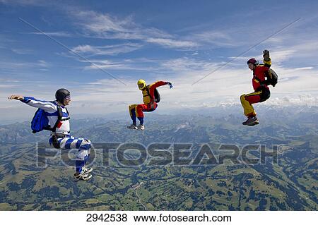 Stock Photo - three people doing parachute jumping, full shot . Fotosearch