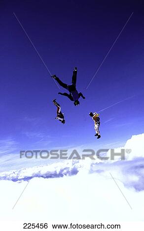 Stock Photograph - Three people skydiving on skateboard . Fotosearch