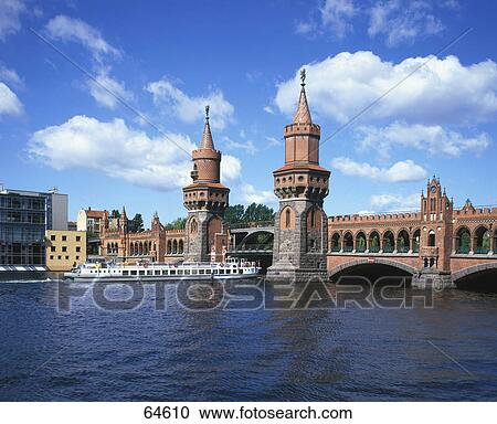 Tour boat in river near bridge, River Spree, Warsaw Bridge, Berlin, Germany View Large Photo Image Stock Image - Tour boat in river near bridge, River Spree, Warsaw Bridge, Berlin, Germany . Fotosearch