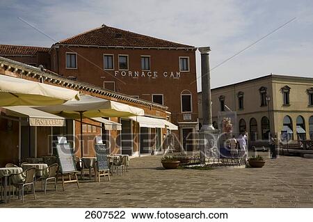 Stock Image - Tourists at market near column sculpture, Isola Murano, Veneto, Venice, Italy . Fotosearch