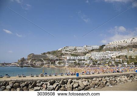 Tourists at the beach of Puerto Rico, Gran Canaria, Canary Islands, Spain View Large Photo Image Stock Photo - Tourists at the beach of Puerto Rico, Gran Canaria, Canary Islands, Spain . Fotosearch