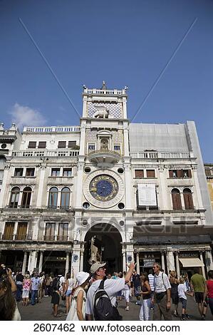 Tourists in front of clock tower, Torre dell'Orologio, St. Mark's Square, Veneto, Venice, Italy View Large Photo Image Stock Image - Tourists in front of clock tower, Torre dell'Orologio, St. Mark's Square, Veneto, Venice, Italy . Fotosearch