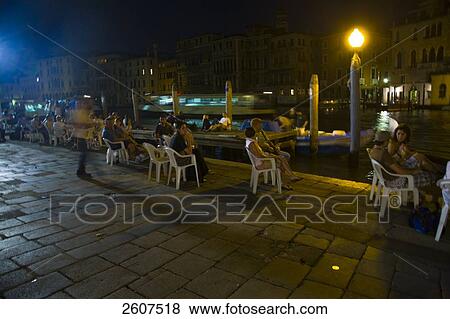 Stock Photo - Tourists near canal at night, Campo Della Pescaria, Veneto, Venice, Italy . Fotosearch