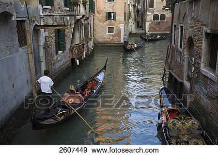 Tourists on gondolas in canal, Grand Canal, Veneto, Venice, Italy View Large Photo Image Stock Photo - Tourists on gondolas in canal, Grand Canal, Veneto, Venice, Italy . Fotosearch