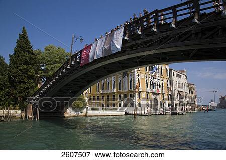 Stock Photo - Tourists standing on bridge across canal, Veneto, Venice, Italy . Fotosearch