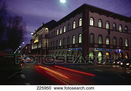 Stock Image - Traffic on road in city at dusk . Fotosearch