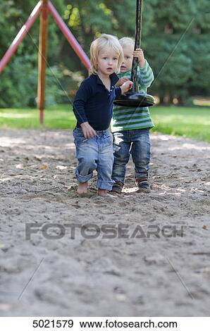 Stock Photo - Two girls at playground . Fotosearch