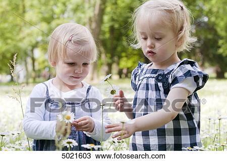 Stock Image - Two girls in park . Fotosearch