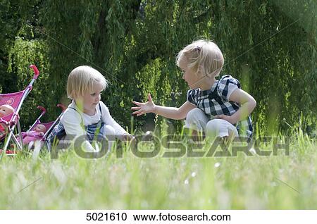 Stock Image - Two girls in park . Fotosearch